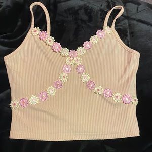 very pretty pinkish cream color. with flowers on the chest